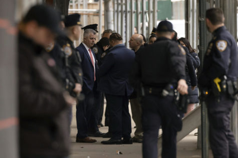 Law enforcement personnel confer outside Manhattan Criminal Court in New York, Friday, March 31, 2023. (AP Photo/Yuki Iwamura)
