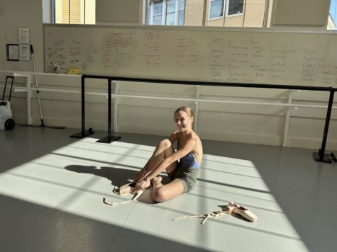 Lyvia Baldner putting on her pointe shoes in Erma Lowe Hall. (Alexis Berry/Staff Writer)