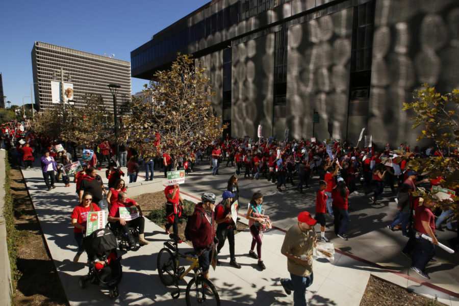 In this Saturday, Dec. 15, 2018, photo, thousands of teachers rally against the nations second-largest school district in downtown Los Angeles. A massive teachers strike in Los Angeles is all but inevitable starting Monday, Jan. 14, 2019, after the two sides did not renew negotiations over the weekend. The teachers union rejected a new offer Friday from the LA Unified School District after hours of talks. United Teachers Los Angeles called the district proposal woefully inadequate. With no new talks scheduled, pickets are likely to begin at 7 a.m. as teachers push for a raise and lower class sizes. (AP Photo/Damian Dovarganes)