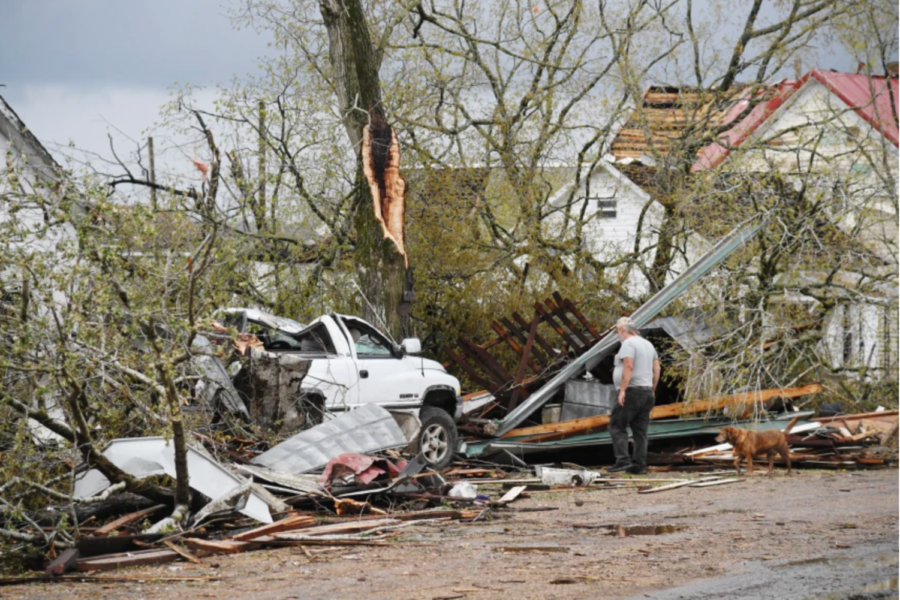 A man looks at the wreck caused by a tornado at home Wednesday in Glenallen, Mo. (NBC News)