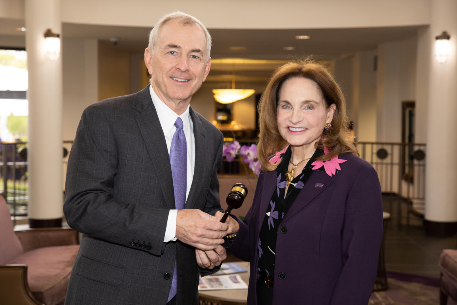 The previous chair, Mark Johnson, passes his gavel to Kit Moncrief. (Photo courtesy of TCU)