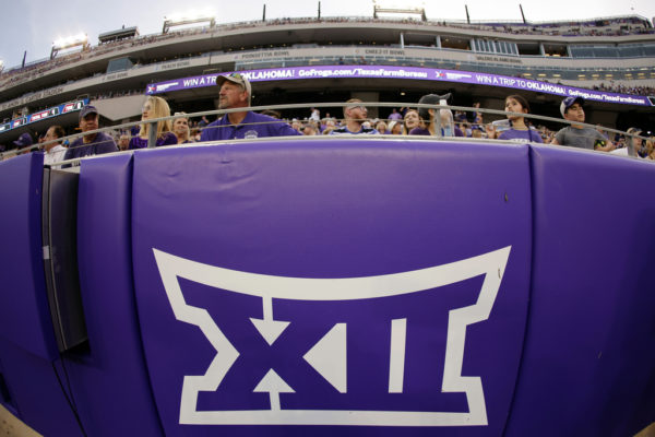 The Big 12 Conference logo is displayed on a barrier at Amon G. Carter Stadium before Duquesne played against TCU in an NCAA college football game in Fort Worth, Texas, Sept. 4, 2021. TCU remained the smallest enrollment in the Big 12 Conference at 10,222, but the Horned Frogs made the College Football Playoff national championship game last season. Their basketball team then made the second round of the NCAA Tournament, and the baseball team went to the College World Series. (AP Photo/Ron Jenkins, File)