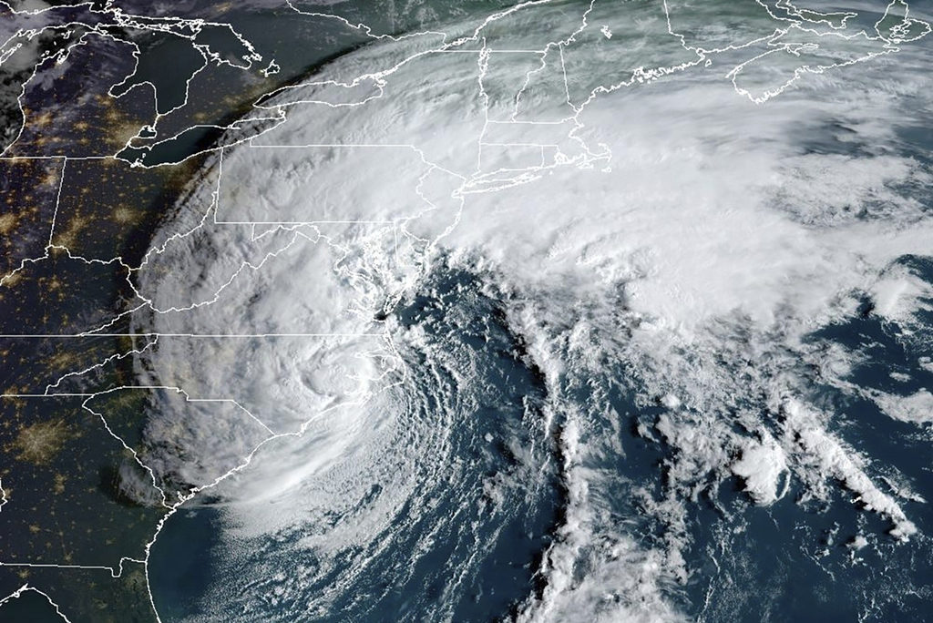 Satellite image provided by the National Oceanic and Atmospheric Administration shows Tropical Storm Ophelia making landfall in North Carolina at 8:16 am, Saturday, Sept. 23, 2023. (NOAA via AP)