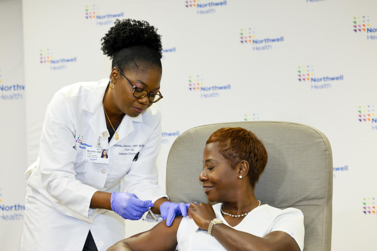 Dr. Michelle Chester, senior director of Employee Health Services at Northwell Health, administers the 2023-24 Pfizer COVID-19 vaccine to Nurse Sandra Lindsay. (Northwell Health)