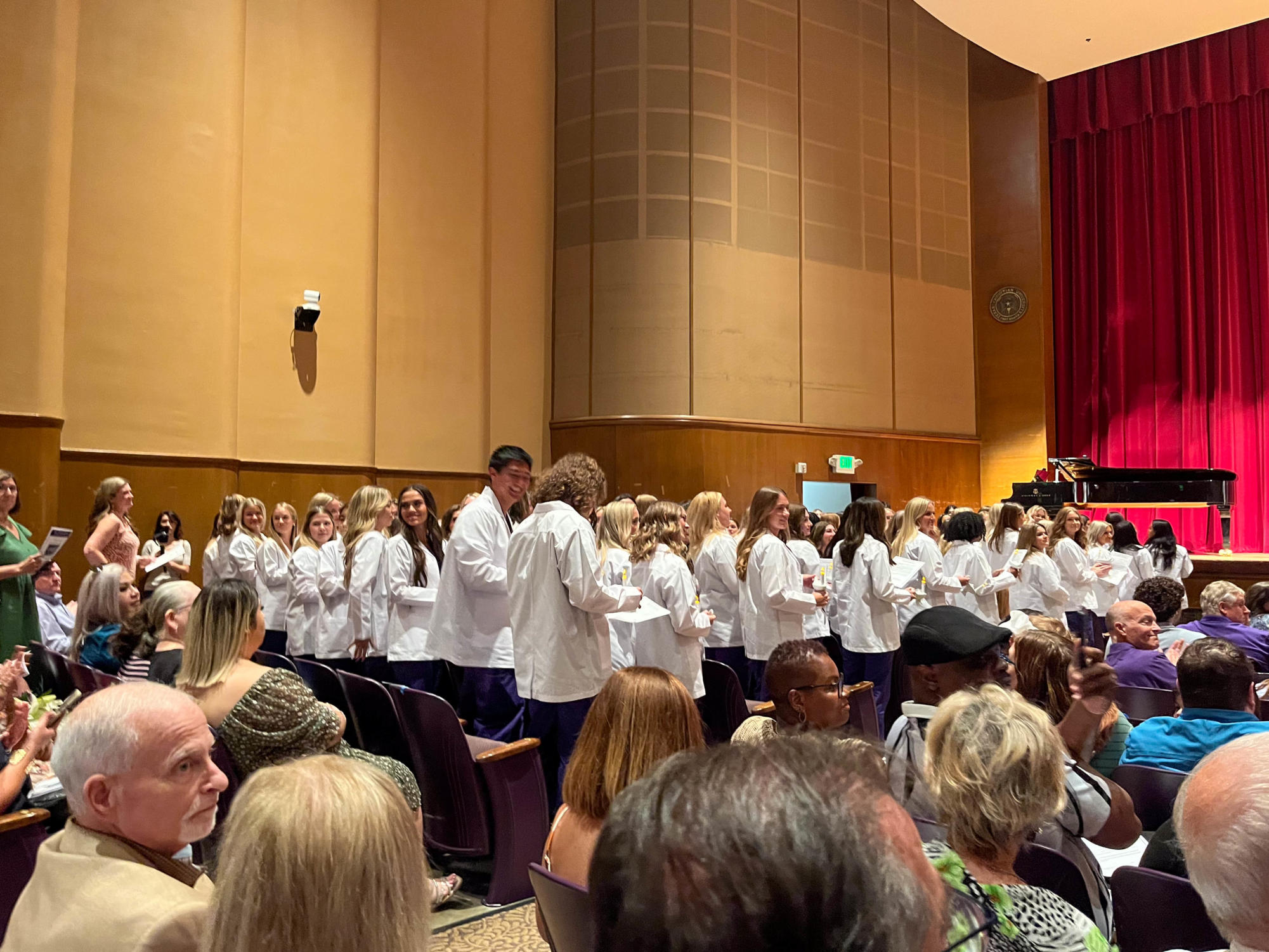 Junior Nursing cohort wearing their white coats; a symbol of their start in the professional medical field. 