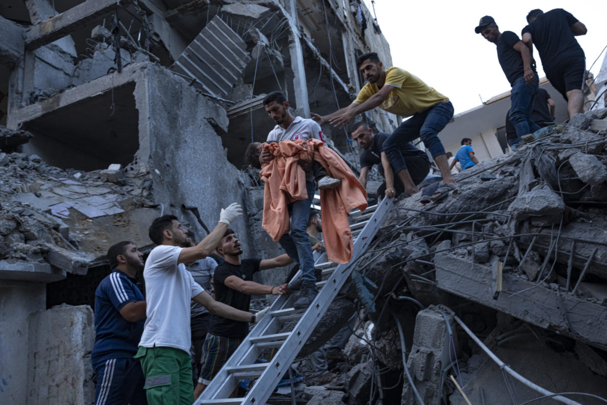 Palestinians+rescue+a+young+girl+from+the+rubble+of+a+destroyed+residential+building+following+an+Israeli+airstrike%2C+Tuesday%2C+Oct.+10%2C+2023.+The+militant+Hamas+rulers+of+the+Gaza+Strip+carried+out+an+unprecedented+attack+on+Israel+Saturday%2C+killing+over+900+people+and+taking+captives.+Israel+launched+heavy+retaliatory+airstrikes+on+the+enclave%2C+killing+hundreds+of+Palestinians.+%28AP+Photo%2FFatima+Shbair%29