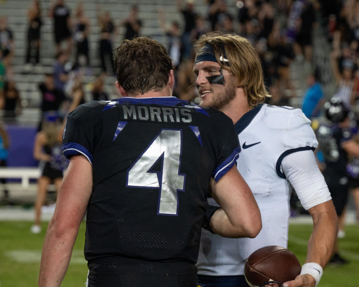 Texas Christian University quarterback Chandler Morris shakes hands with West Virginia quarterback Garrett Greene at Amon G. Carter Stadium in Fort Worth, Texas, Sept. 30, 2023. The TCU Horned Frogs were defeated by the West Virginia Mountaineers 24-21. (TCU 360/ Shane Manson)