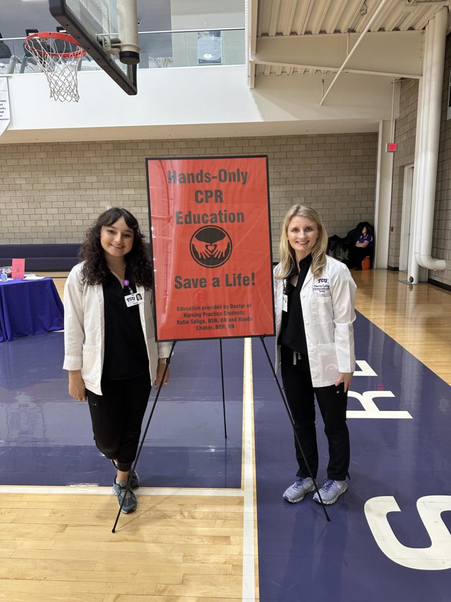Two students studying to be nurse practitioners give out CPR sessions at flu clinic. (Sasha Chapman/Staff Writer)