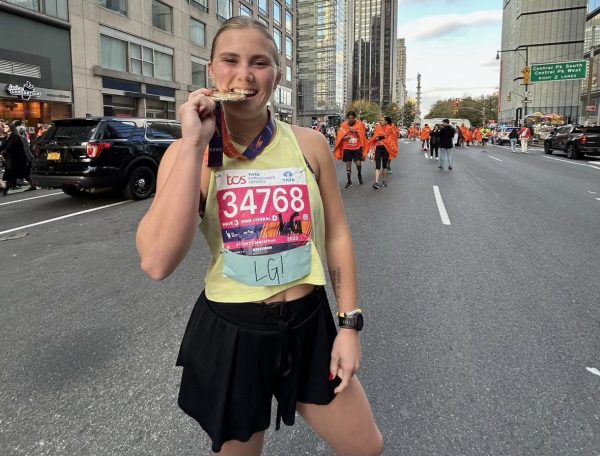 Lauren Grace Perry poses with her medal after completing the New York City Marathon. (Photo courtesy of: Janet and Chris Perry)