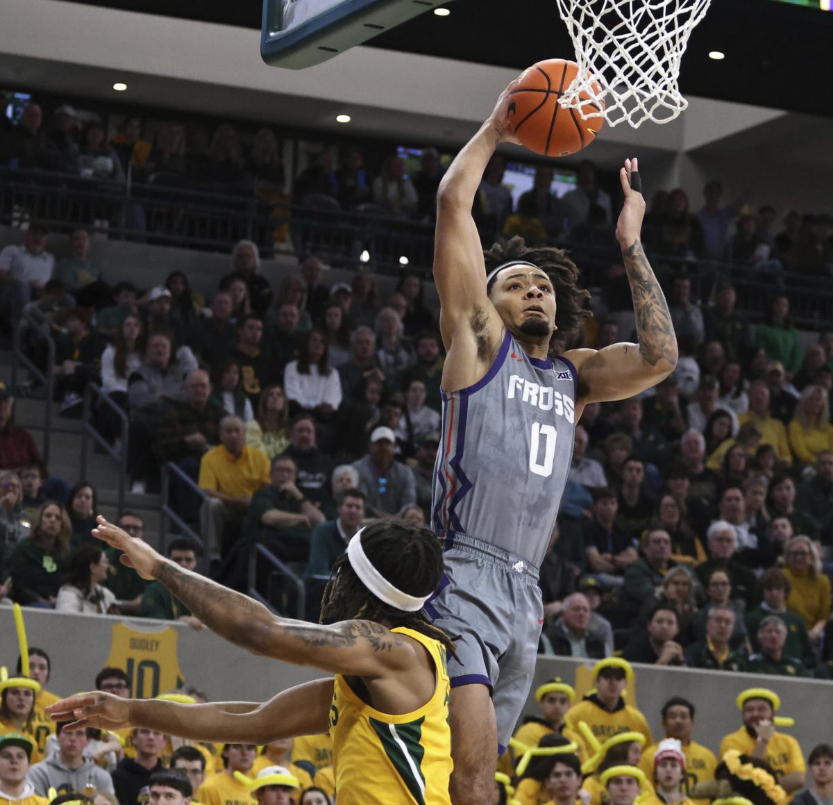 TCU guard Micah Peavy scores over Baylor guard Jayden Nunn in the first half of an NCAA college basketball game, Saturday, Jan. 27, 2024, in Waco, Texas.