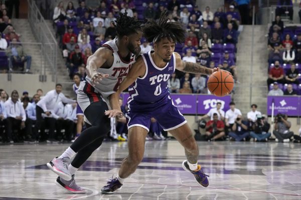 TCU guard Micah Peavy (0) works against Texas Tech s Joe Toussaint (6) for a shot opportunity in the first half of an NCAA college basketball game in Fort Worth, Texas, Tuesday, Jan. 30, 2024. (AP Photo/Tony Gutierrez)


