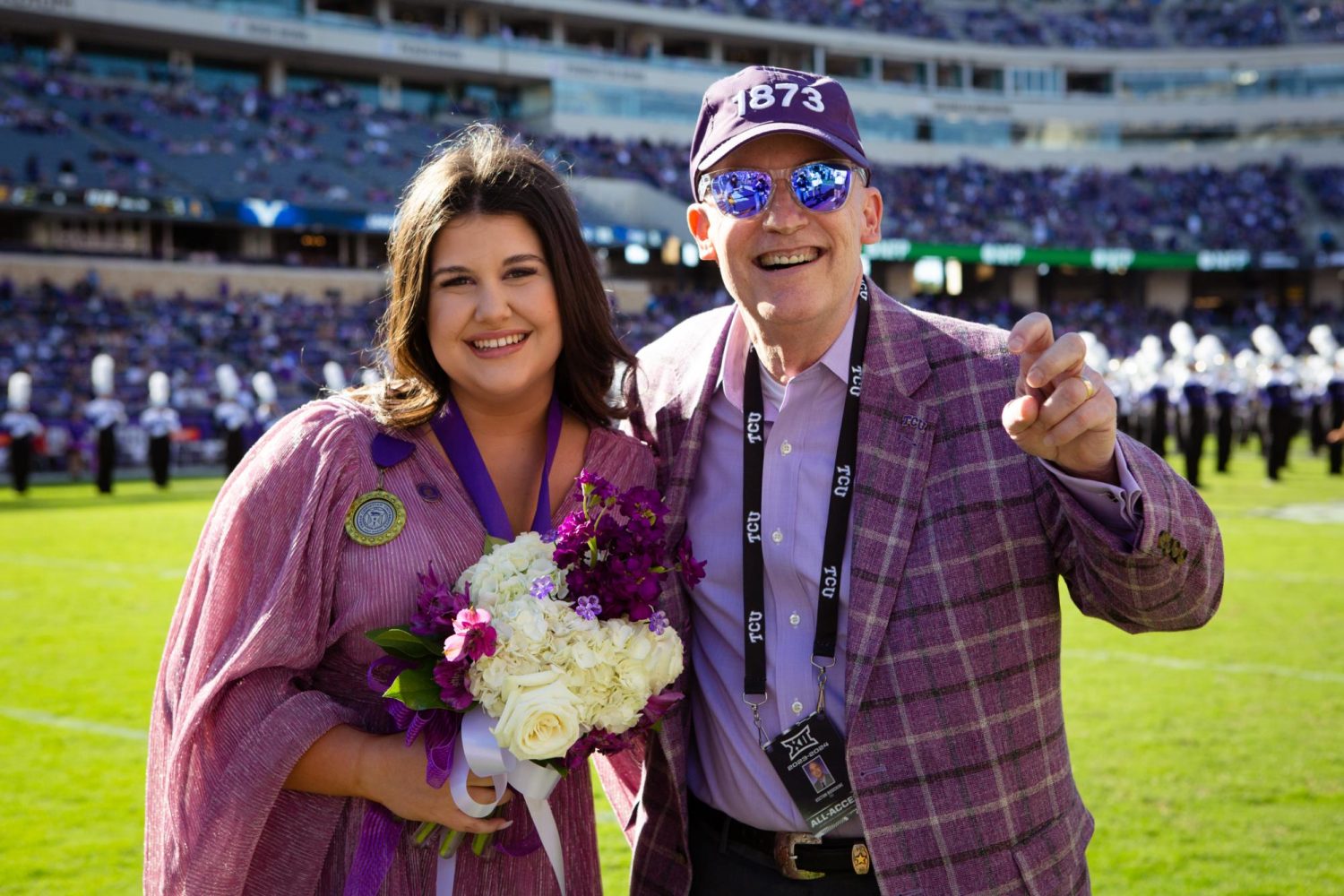 Marina Magnant smiles with Chancellor Boschini on the football field after being announced as TCU’s outstanding senior at halftime of the homecoming football game against BYU. (Photo courtesy of Amy Peterson)
