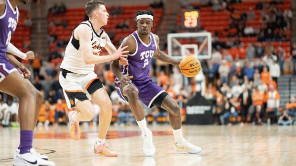 Emanuel Miller, who led the team in points with 21 against Oklahoma State, driving to the basket in the Frogs road win on Tuesday. (photo courtesy of: grofrogs.com)