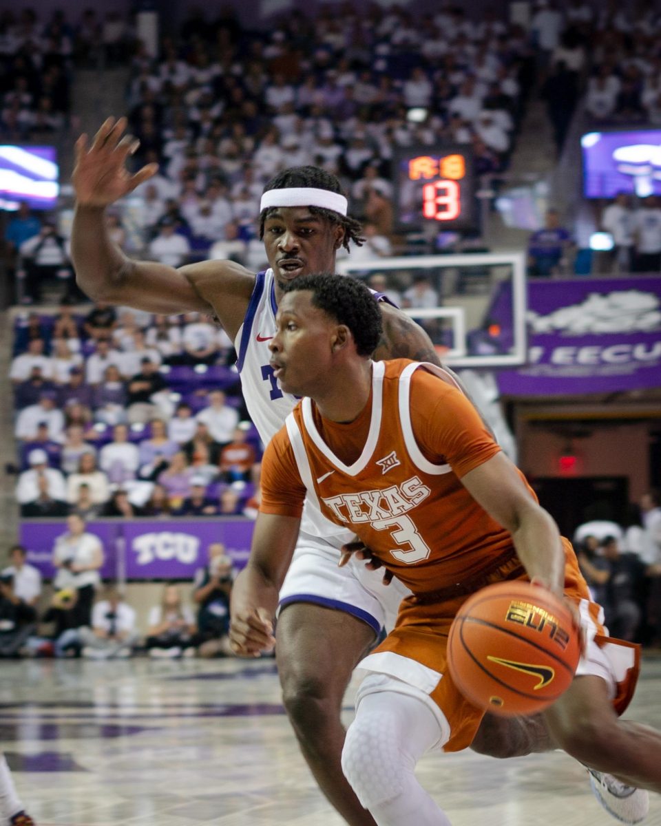 TCU forward Emanuel Miller defends Texas Longhorns guard Max Abmas at Ed and Rae Schollmaier Arena, Feb. 3, 2024. The TCU Horned Frogs lost to the Texas Longhorns 66-77. (TCU 360/ Shane Manson)