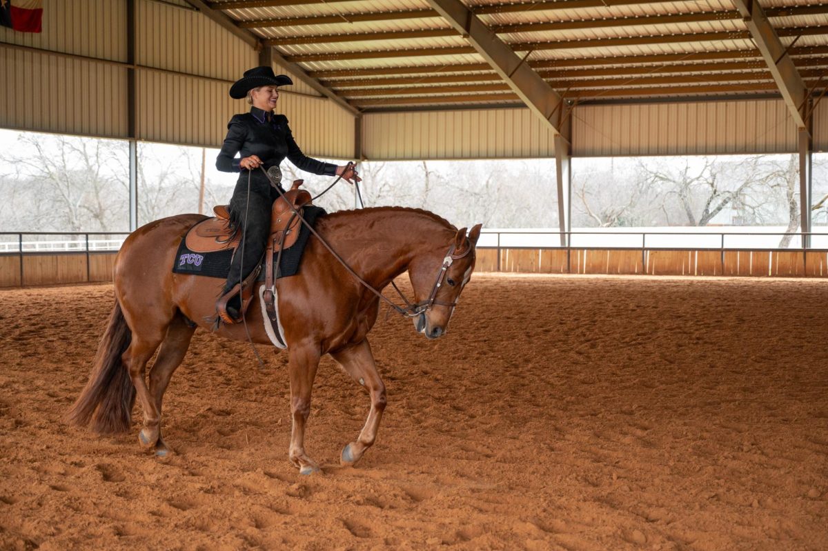 Shea Graham as she prepares to ride Dewey in Horsemanship. (Billy Banks / Staff Photographer)