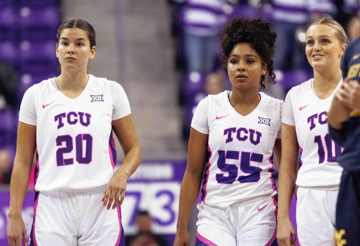 TCU guards Ella Hamlin (left), Victoria Flores (center), and Piper Davis (right) look onwards at Ed and Rae Schollmaier Arena in Fort Worth, Texas on February 13th, 2024. The TCU Horned Frogs fell to the West Virginia Mountaineers 77-52. (TCU360/ Tyler Chan)