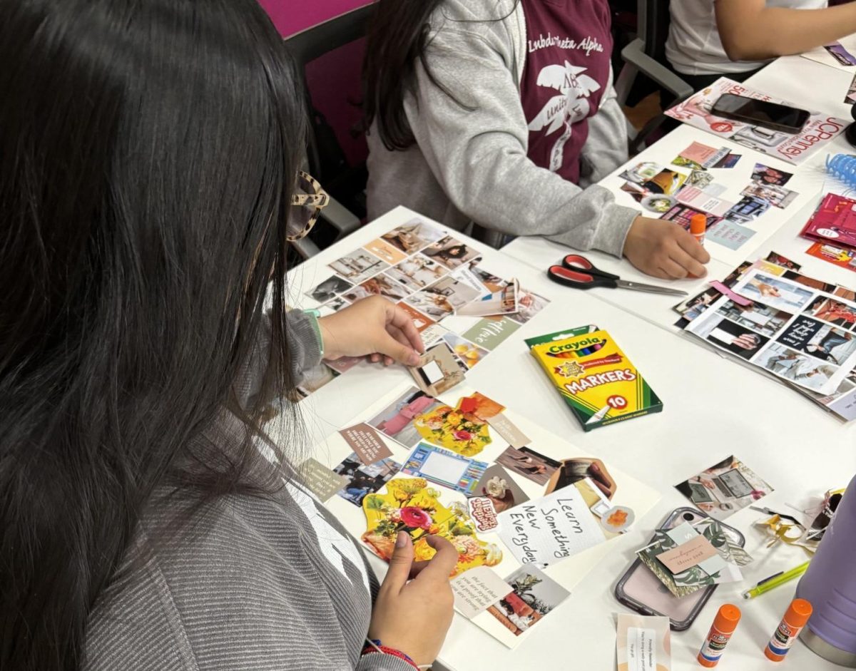 A potential new member of Lambda Theta Alpha makes a vision board on Monday, Feb. 5th in TCUs Intercultural Center. (Aliyah Howell/Staff Writer)
