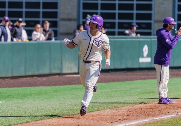 TCU first basemen and catcher Karson Bowen celebrates while rounding the bases after hitting a home run at Lupton Stadium in Fort Worth, Texas on February 18th, 2024. The TCU Horned Frogs beat the Florida Gulf Coast Eagles 11-6. (Tyler Chan/Staff Photographer)