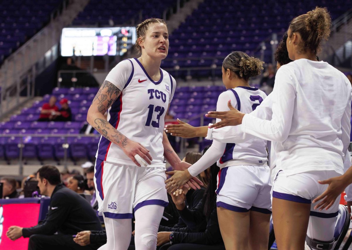 TCU center Sedona Prince high fives her teammates at Ed and Rae Schollmaier Arena in Fort Worth, Texas on February 24th, 2024. The TCU Horned Frogs beat the Houston Cougars 59-49. (TCU360/ Tyler Chan)