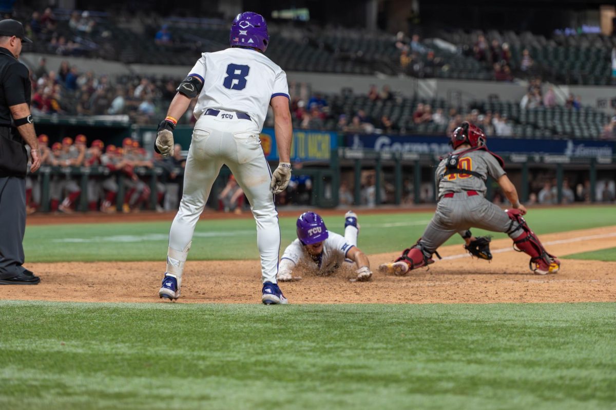 Chase Brunson slides into home to score the winning run in extra innings against the USC Trojans. March 1, 2024 at Globe Life Field. 