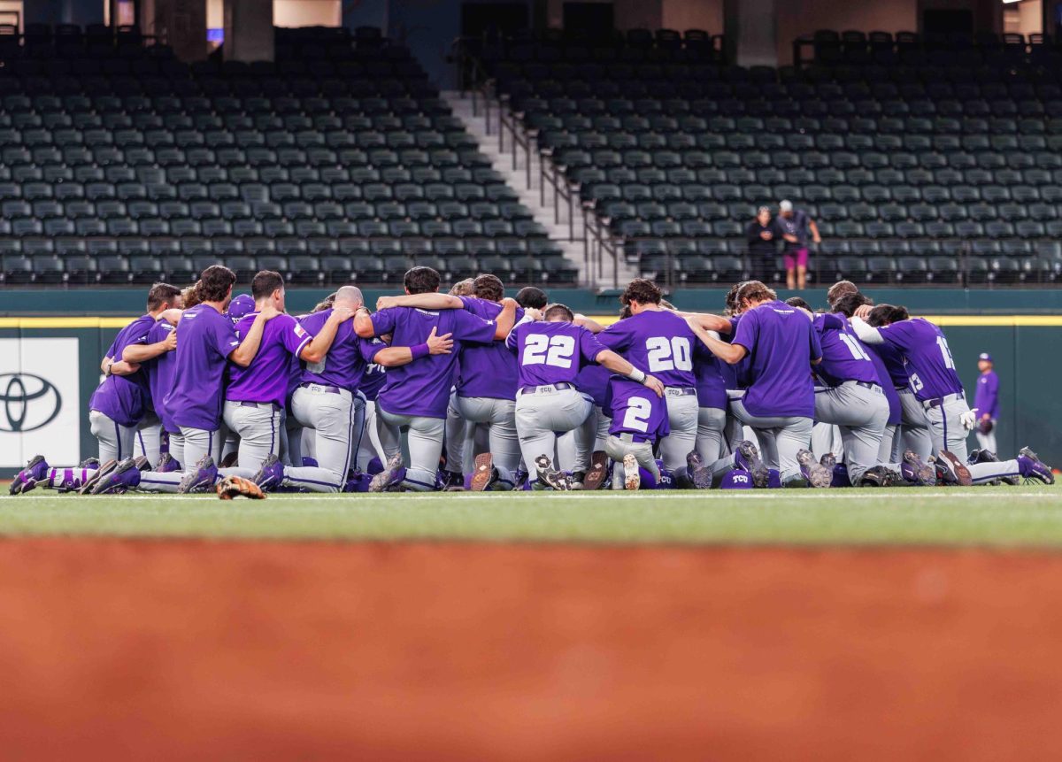 The TCU baseball team prays before their game at Globe Life Field in Arlington, Texas on March 3rd, 2024. The TCU Horned Frogs beat the USC Trojans 9-5. (TCU360/Tyler Chan)