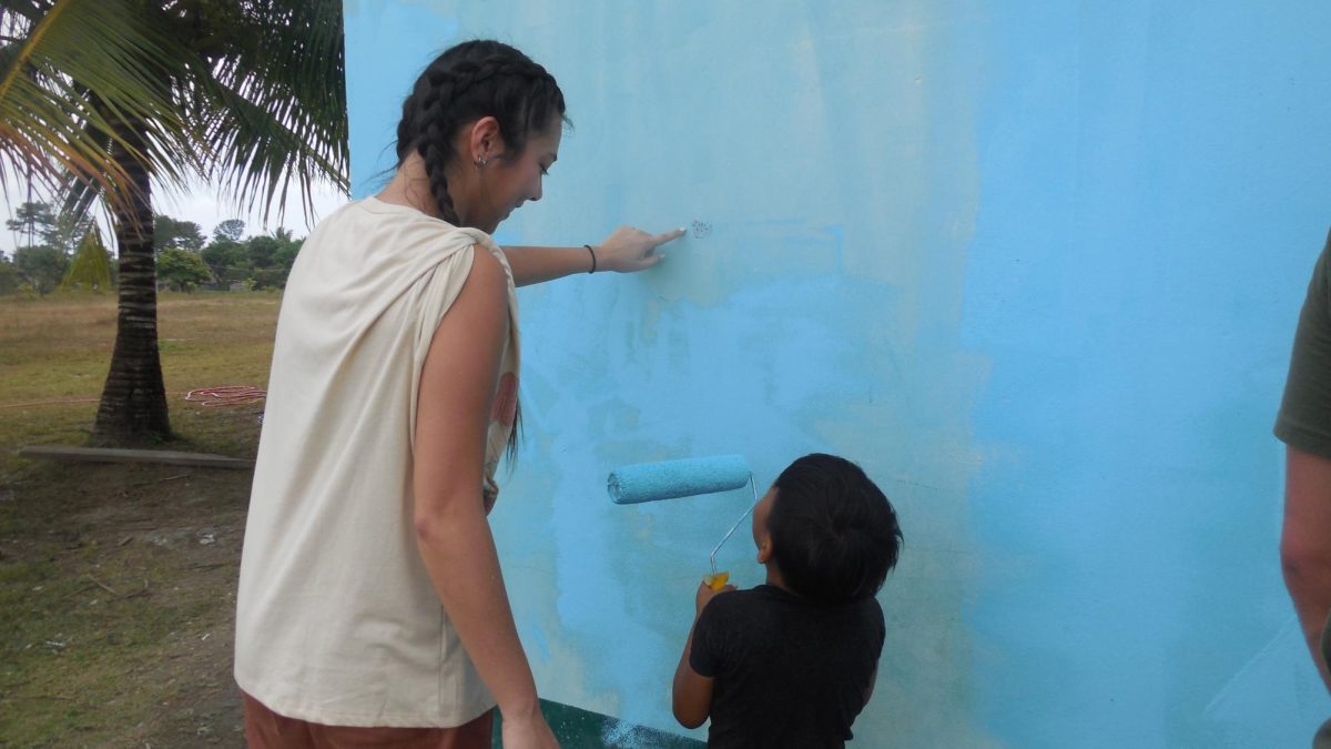 Delaney Vega, a TCU journalism junior, is painting a school in Belize. (Courtesy of Teja Sieber)