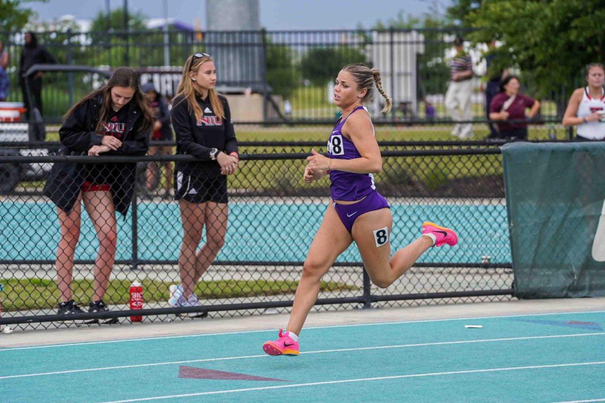 Rylan Engels competes in the women’s 800 meter race on an outdoor track. (Courtesy of gofrogs.com)