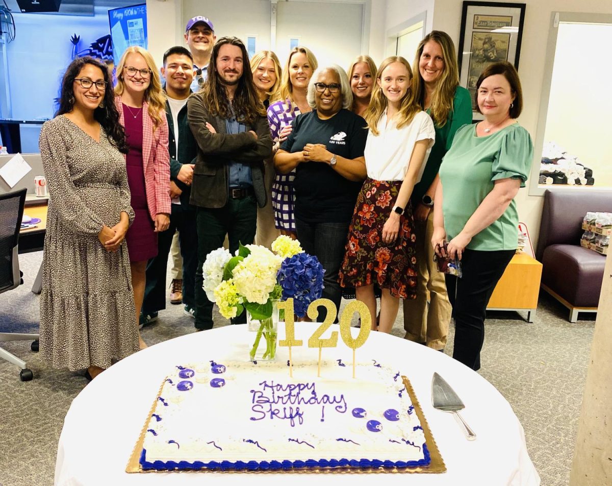 A group of Student Media alumni pose with Student Media Director Jean Marie Brown during The Skiffs 120th birthday party on Sept. 19, 2022, in the student newsroom.