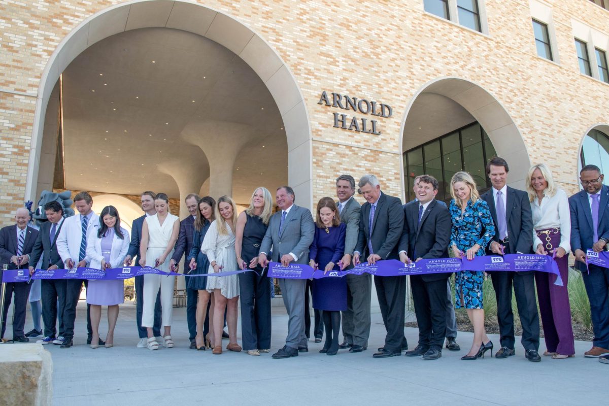 Members of the TCU community cut the ribbon during the dedication of Arnold Hall, Sept. 24, 2024. (TCU 360 Photo by Shane Manson)