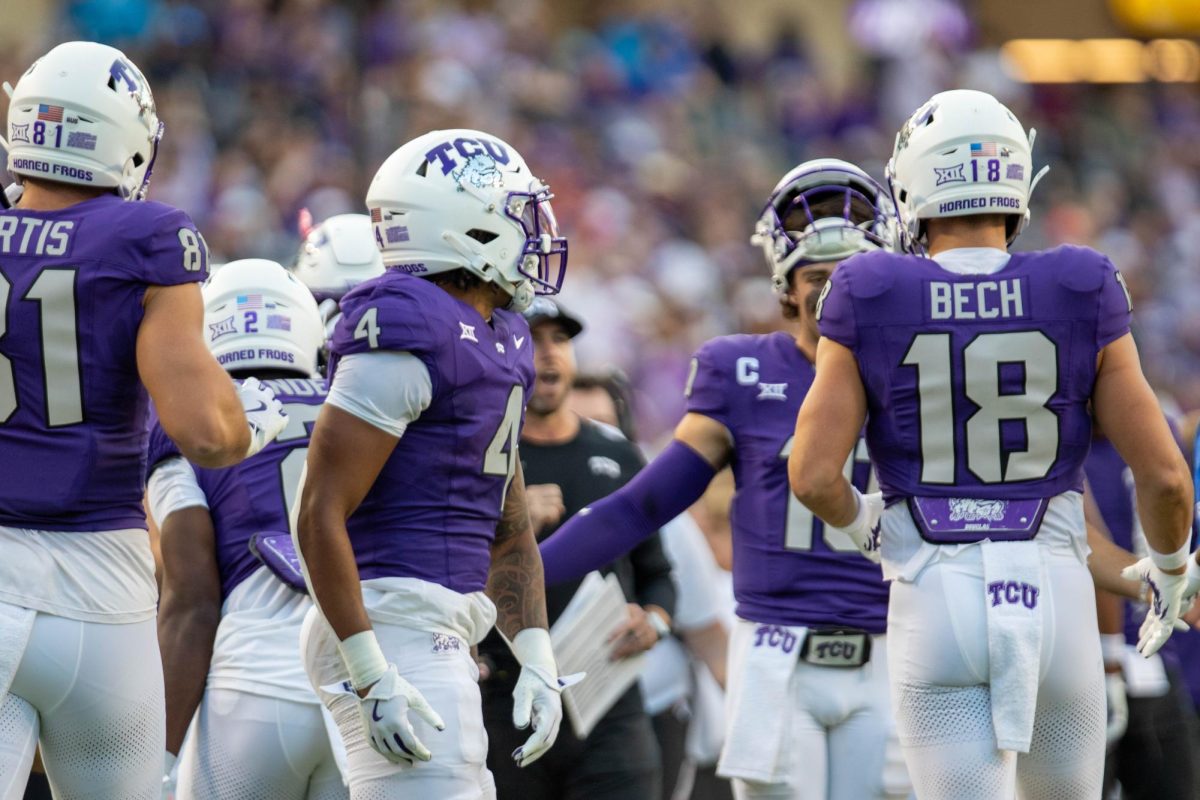 Jack Bech and Cam Cook celebrating a touchdown with his teammates. 