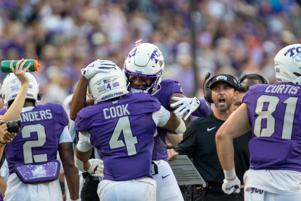 Cam Cook celebrating a touchdown with his teammates.