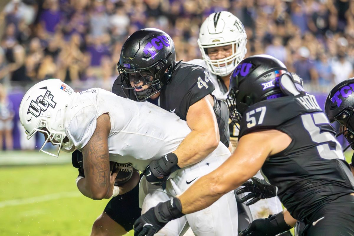 Cooper McDonald and Johnny Hodges tackiling the quaterback from UCF