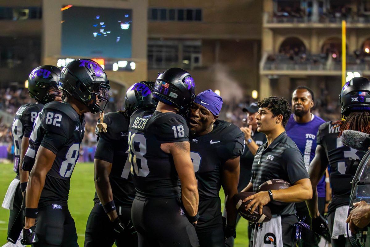 Jack Bech celebrating his first touchdown with his fellow teammates. 