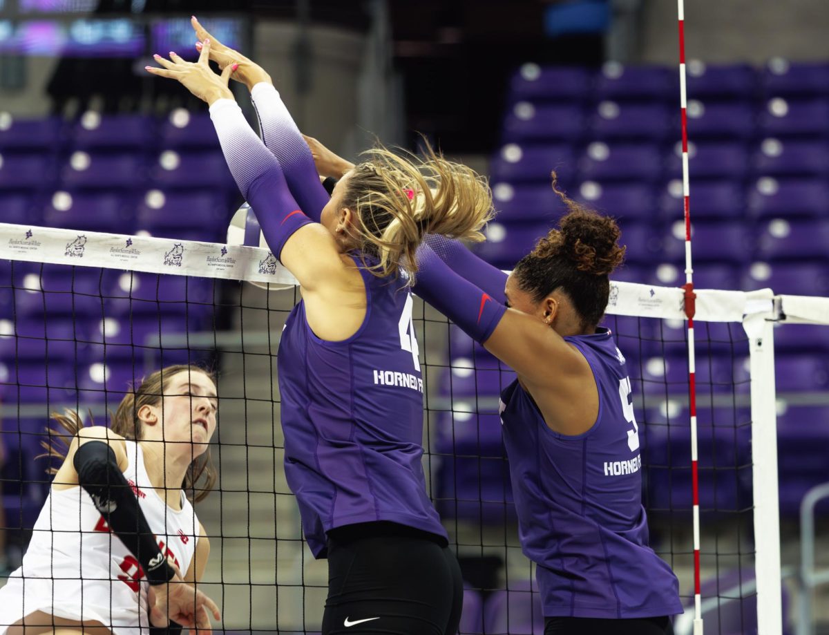 TCU Volleyball's Sarah Sylvester and Jalyn Gibson block the ball over the net at Schollmaier Arena in Fort Worth, Texas on September 20, 2024. The TCU Horned Frogs swept the Denver Pioneers 3-0.