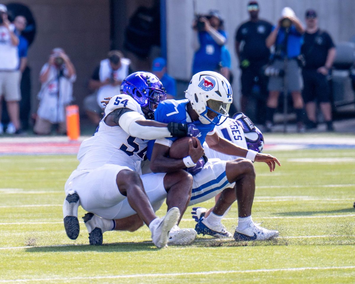 Johnny Hodges and NaNa Osafo-Mensah tackle QB Kevin Jennings at Gerald J. Ford Stadium, Sept. 21, 2024. The TCU Horned Frogs were defeated by the SMU Mustangs 44-66. (TCU 360 Photo by Shane Manson)