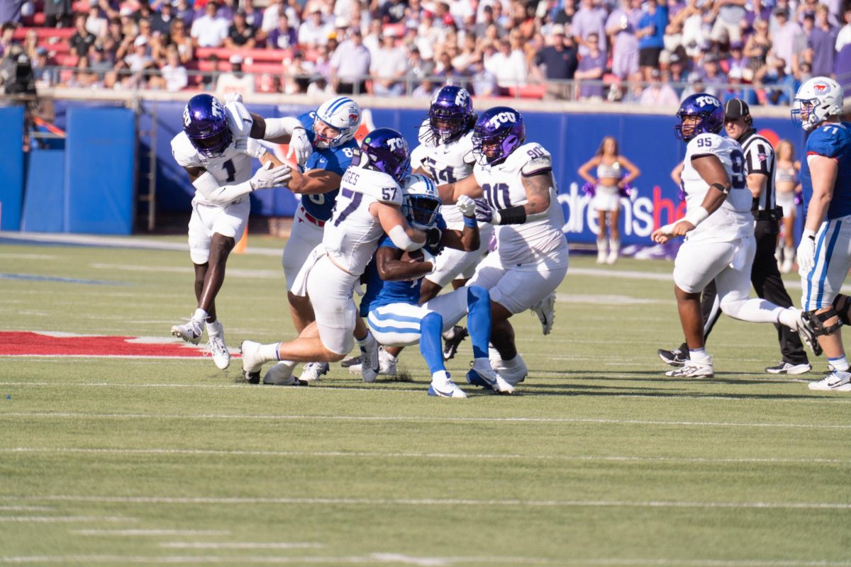 The TCU defensive unit makes a tackle at Gerald J. Ford Stadium, Sept. 21, 2024. The TCU Horned Frogs were defeated by the SMU Mustangs 44-66. (TCU 360 Photo by Shane Manson)