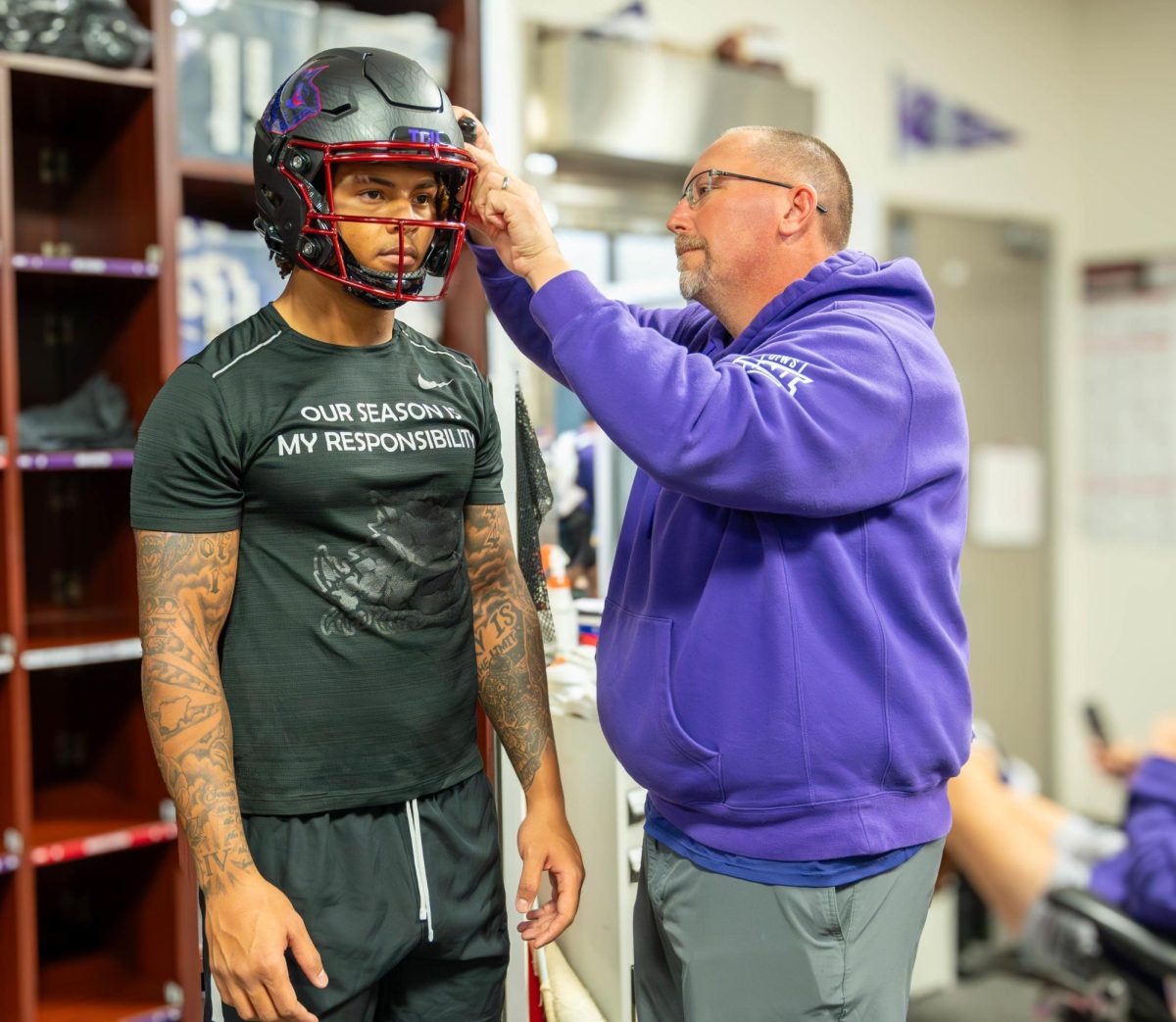 Linebacker Namdi Obiazor has his helmet fitted prior to a home game against Baylor in 2023.