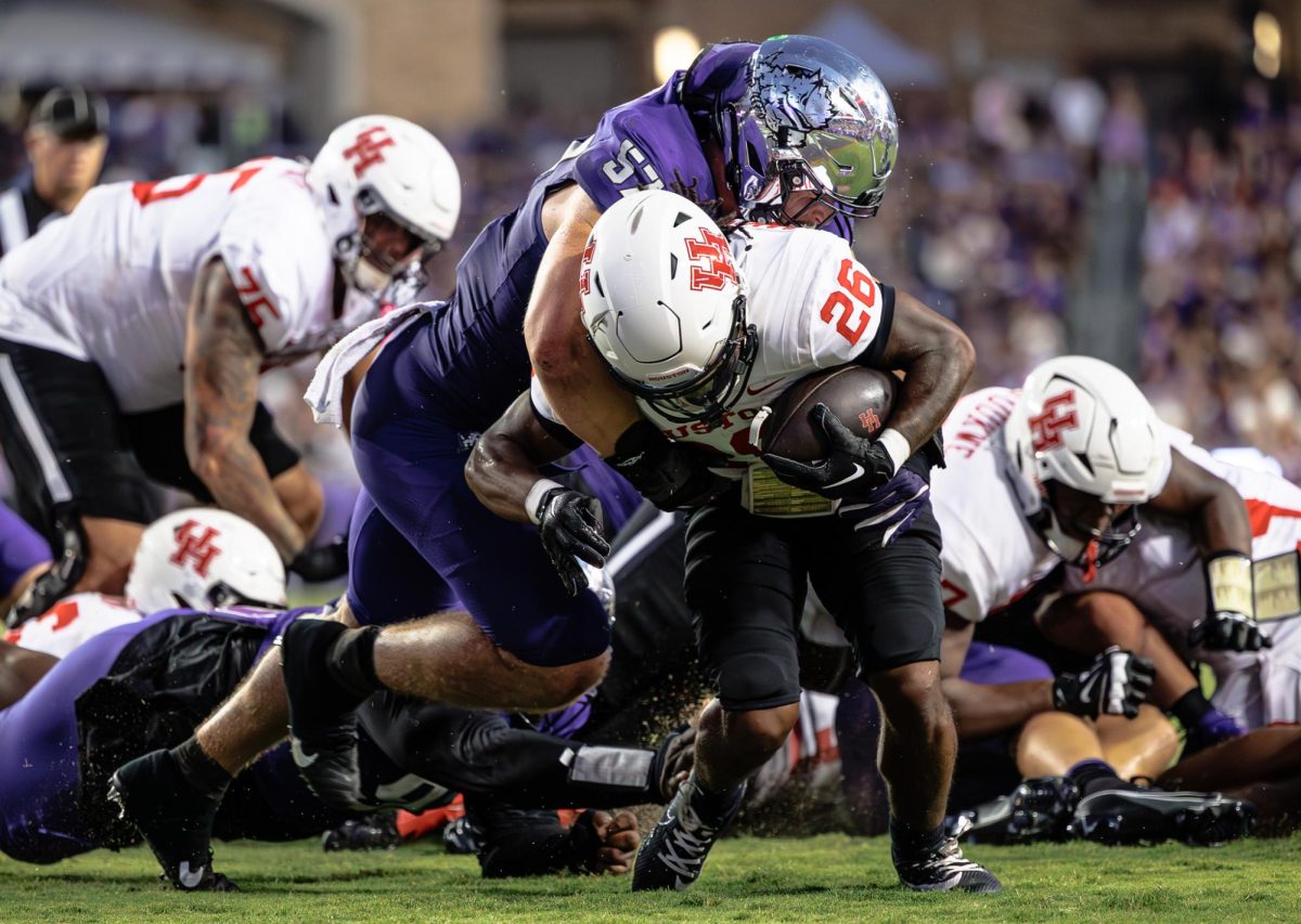 TCU linebacker Johnny Hodges tackles Houston's running back Re'Shaun Sanford II at Amon G. Carter Stadium in Fort Worth, Texas on October 4th, 2024. The TCU Horned Frogs fell to the Houston Cougars 19-31 (TCU360/Tyler Chan)