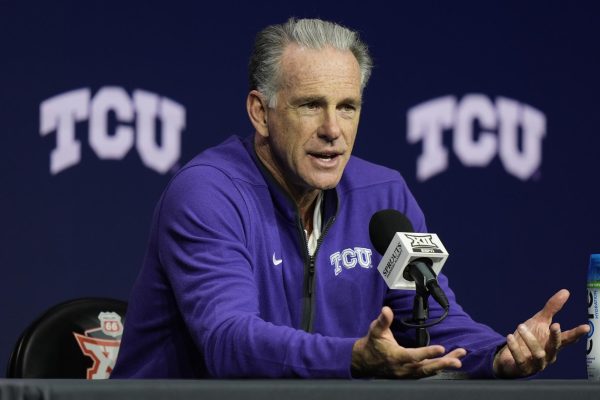 TCU head coach Jamie Dixon addresses the media during the NCAA college Big 12 men's basketball media day, Wednesday, Oct. 23, 2024, in Kansas City, Mo. (AP Photo/Charlie Riedel)