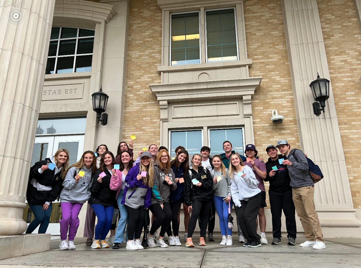 Club members outside of a TCU campus building as they hand out their weekly kind-worded sticky notes. (Courtesy of Katie Nguyen/IOW Marketing Chair)