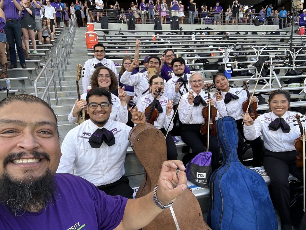 TCU Mariachi Sangre Royal poses in the bleachers before their captivating performance. (Courtesy of TCU Mariachi Sangre Royal)