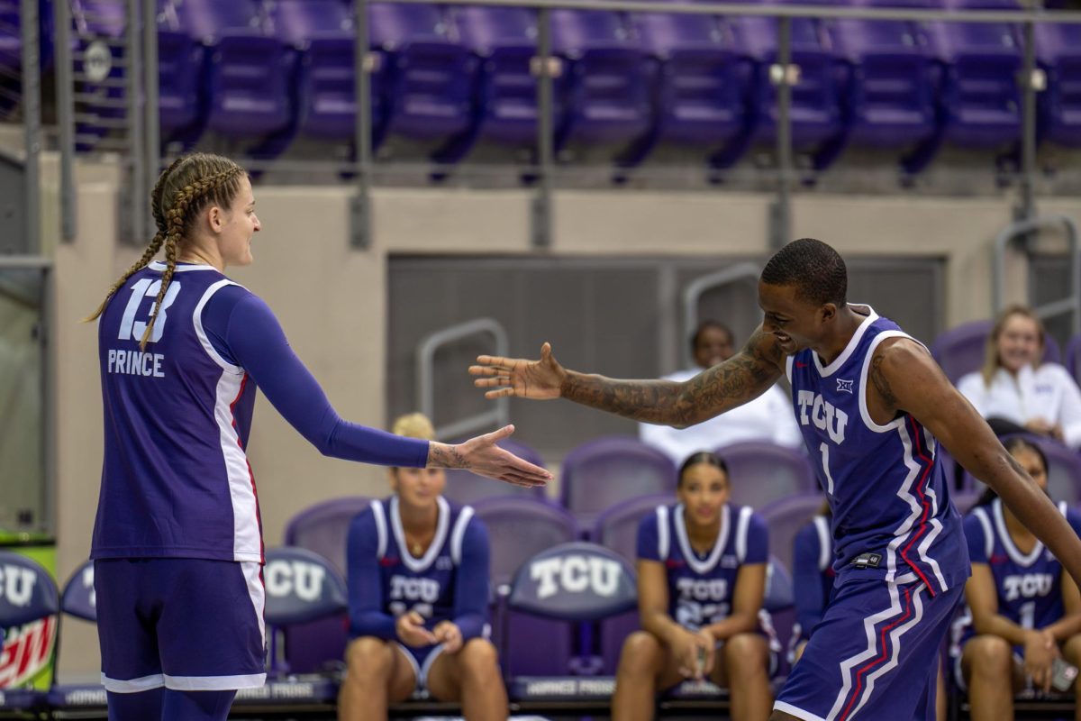 Sedona Prince and Isaiah Manning dap up at Schollmaier Live, Oct. 25, 2024.