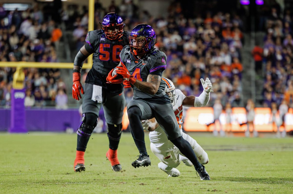 TCU running back Cam Cook runs away from a defender at Amon G. Carter Stadium in Fort Worth, Texas on November 9th, 2024. The TCU Horned Frogs beat the Oklahoma State Cowboys 38-13. (TCU360/ Tyler Chan)