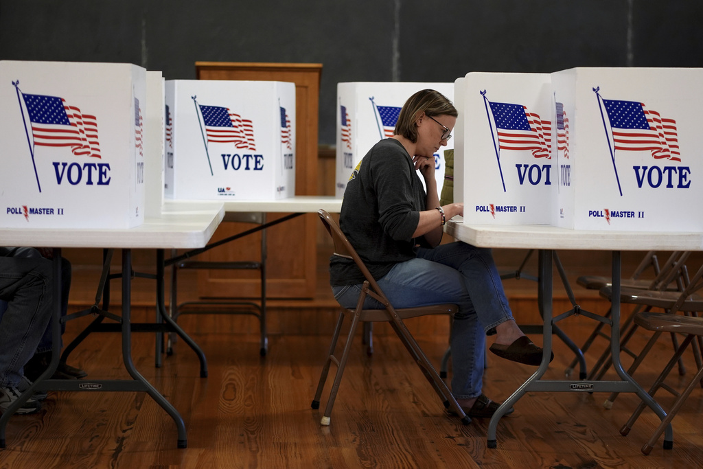 Kristin Scruggs votes at the 146-year-old Buck Creek school Tuesday, Nov. 5, 2024, in rural Perry, Kan. (AP Photo/Charlie Riedel)