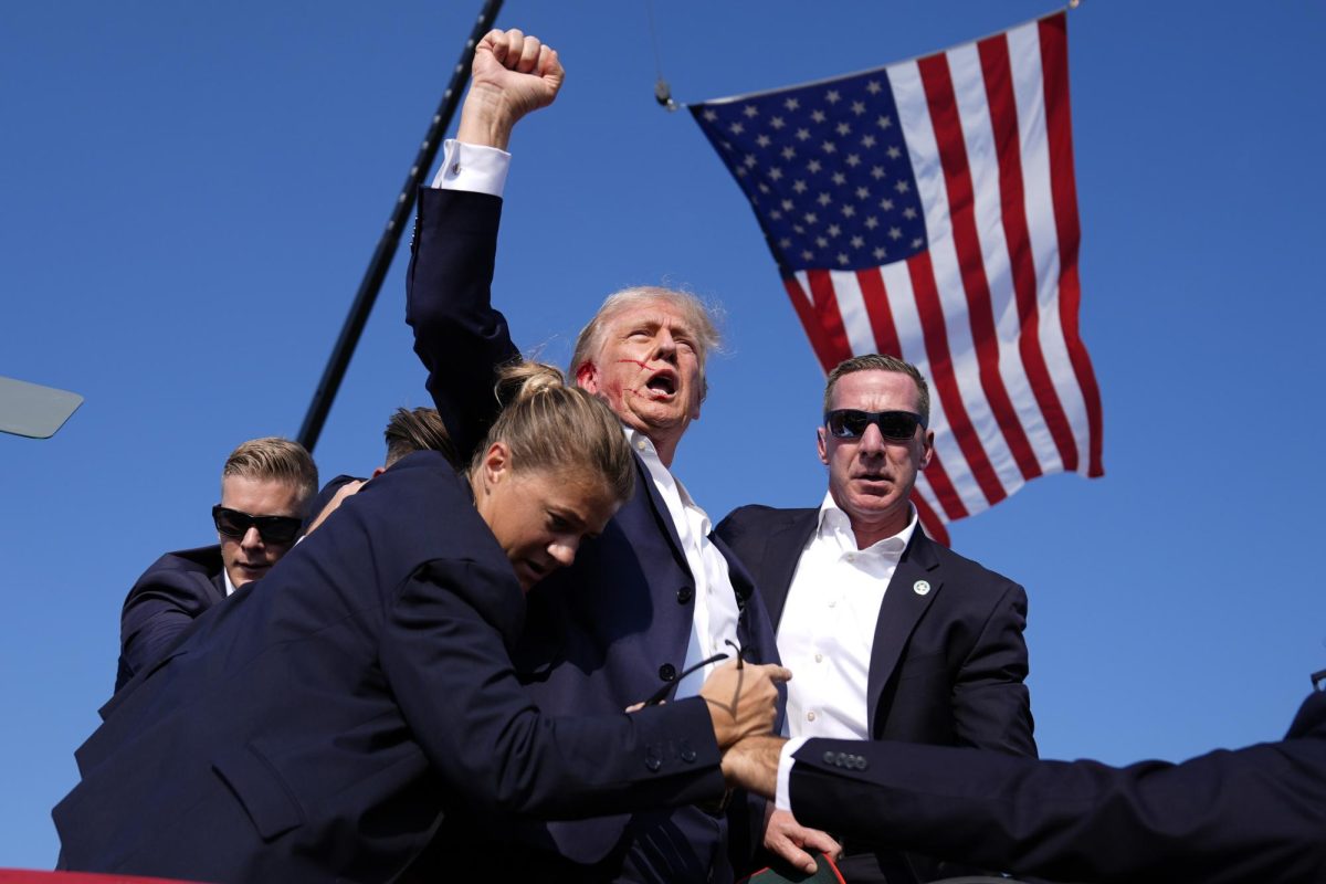 Donald Trump is surrounded by U.S. Secret Service agents at a campaign rally, Saturday, July 13, 2024, in Butler, Pa. (AP Photo courtesy of Evan Vucci)