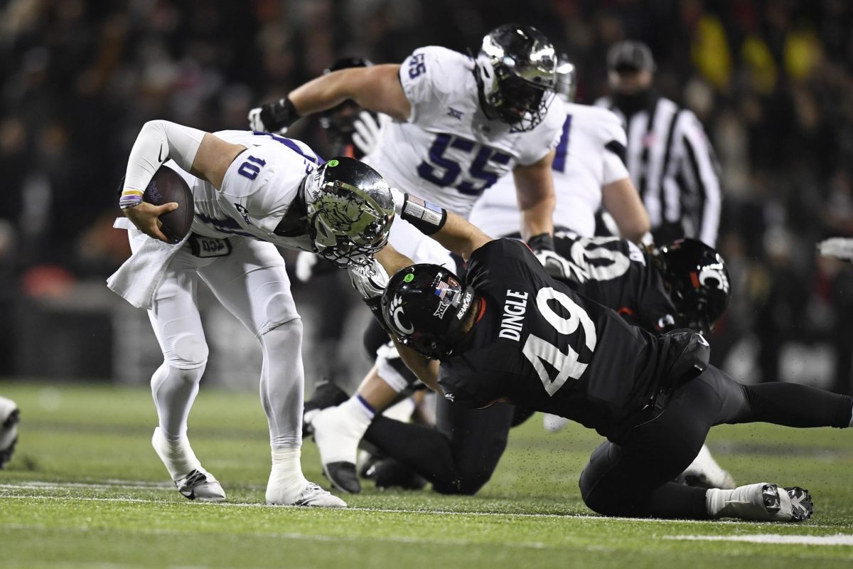 CINCINNATI, OH - NOVEMBER 30: Texas Christian Horned Frogs Quarterback Josh Hoover (10) escapes the sack of Cincinnati Bearcats Linebacker Jack Dingle (49) during the college football game between the Texas Christian Horned Frogs and the Cincinnati Bearcats on November 30, 2024, at Nippert Stadium in Cincinnati, Ohio. (Photo by Michael Allio/Icon Sportswire) (Icon Sportswire via AP Images)