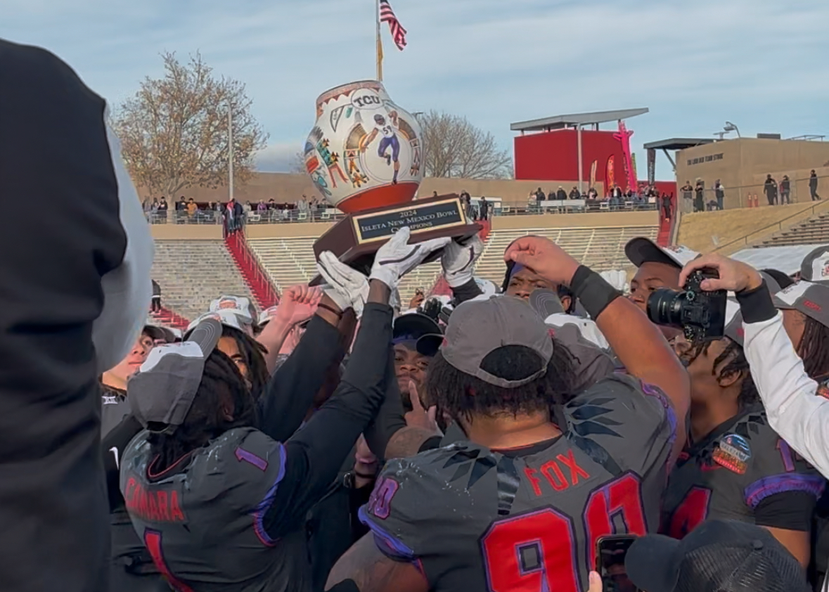 TCU Football hoists the trophy after winning the Isleta New Mexico Bowl on Dec. 28, 2024.