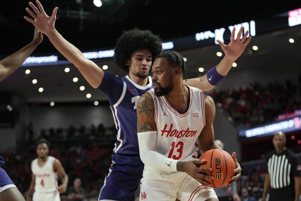 TCU forward David Punch defends against Houston forward J'Wan Roberts (13) during the first half of an NCAA college basketball game in Houston, Monday, Jan. 6, 2025. (AP Photo/Ashley Landis)


