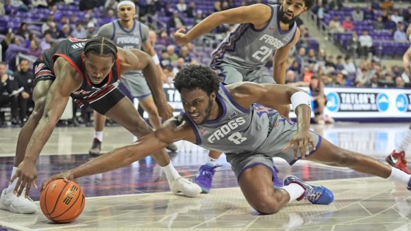 TCU center Ernest Udeh Jr. (8) and Utah forward Ezra Ausar (2) reach for the ball during the second half of an NCAA college basketball game Wednesday, Jan. 15, 2025, in Fort Worth, Texas. (AP Photo/LM Otero)