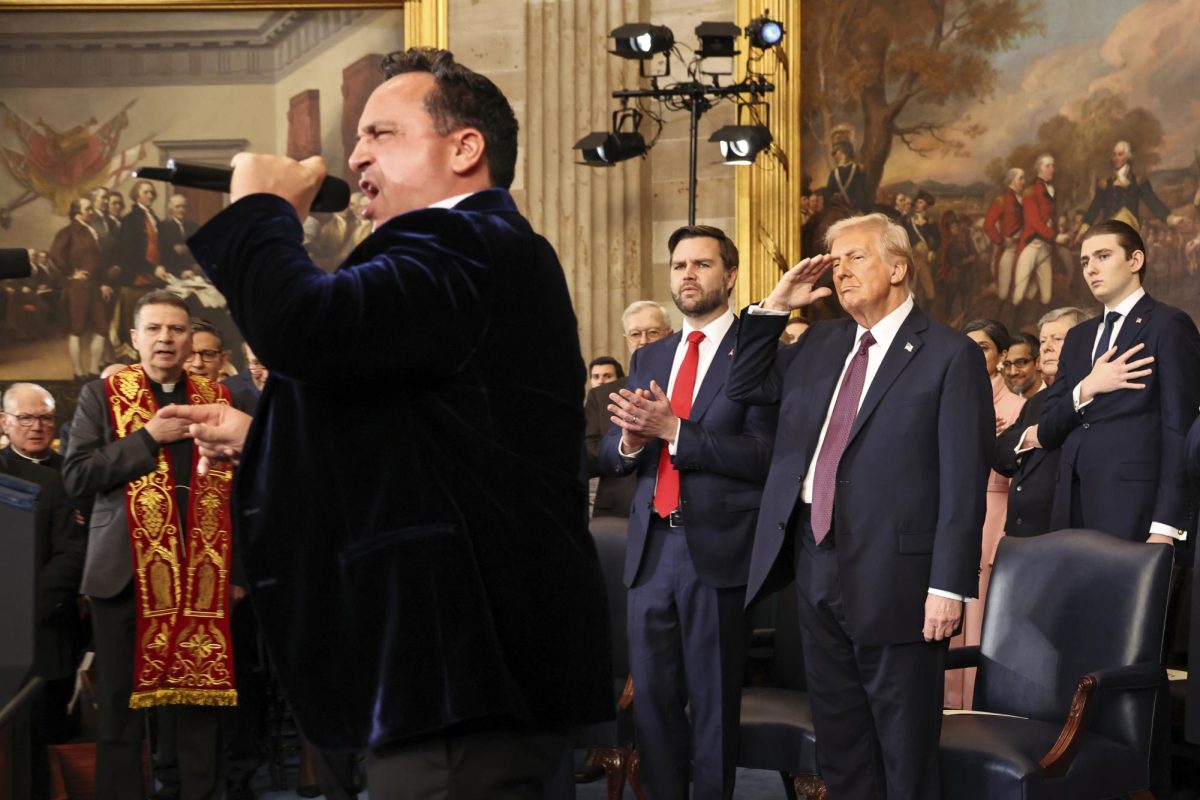 President Donald Trump salutes as opera singer Christopher Macchio performs during the 60th Presidential Inauguration in the Rotunda of the U.S. Capitol in Washington, Monday, Jan. 20, 2025. (Chip Somodevilla/Pool Photo via AP)